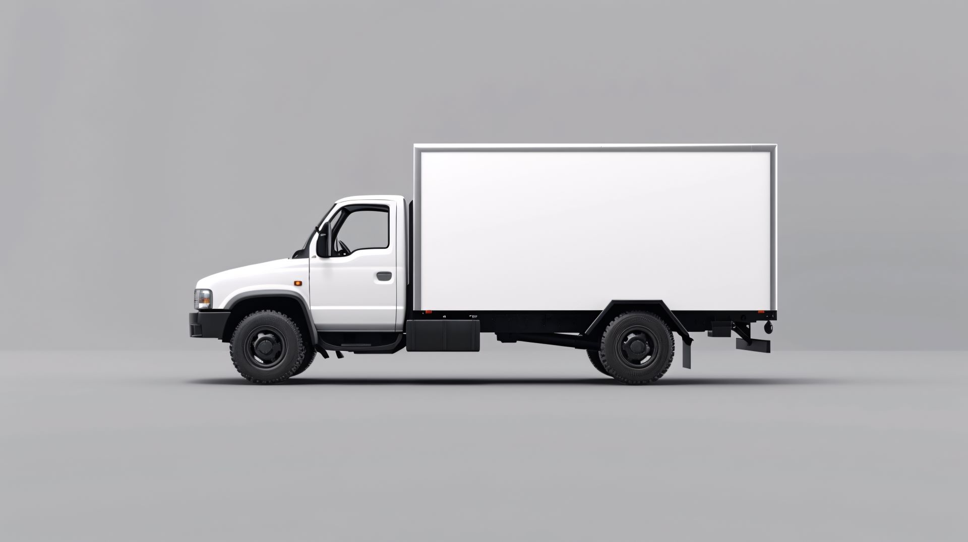 White upfit commercial vehicle with large box on chassis on grey background